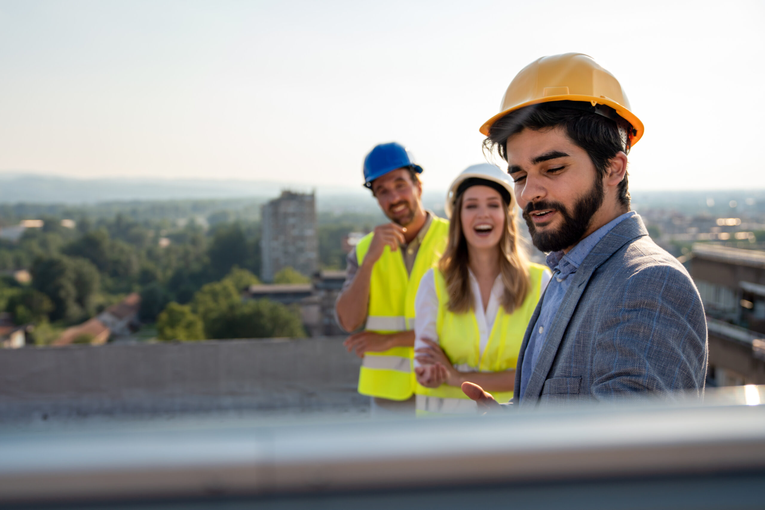 Group of engineers and architects working at construction site with blueprint